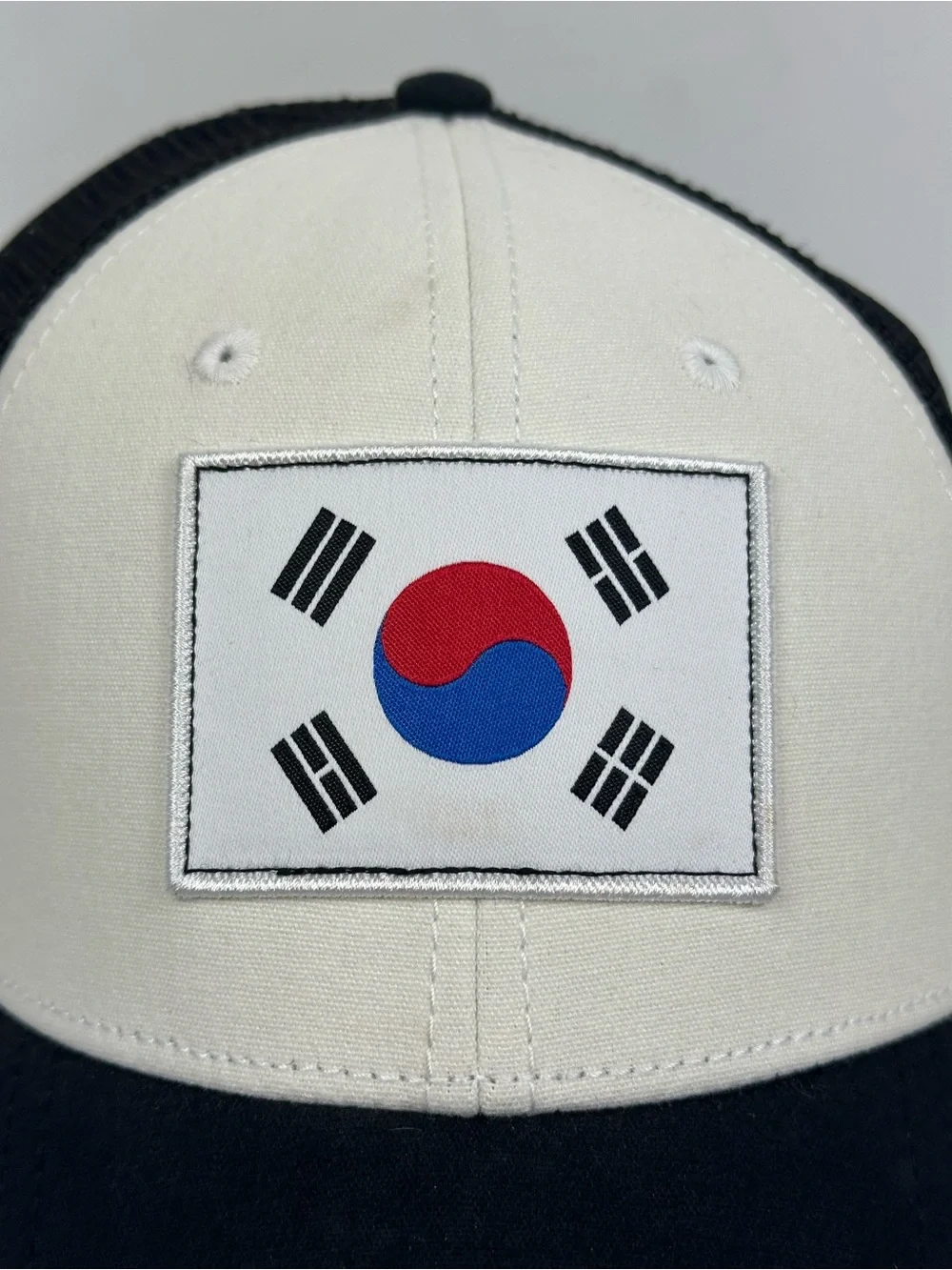 The North Face Black & White Trucker Hat with South Korea Flag Patch